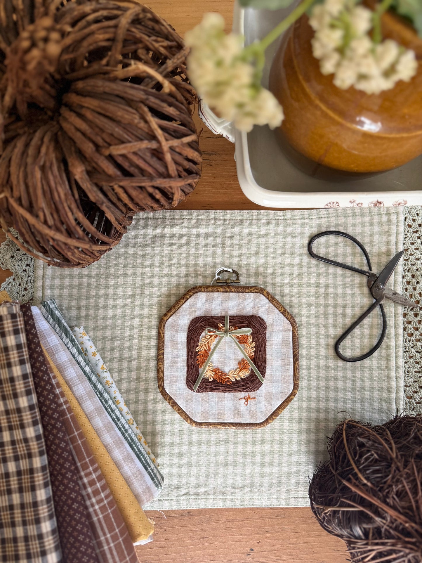 Large Brown Wicker Frame with Fall Wreath on Gingham Fabric