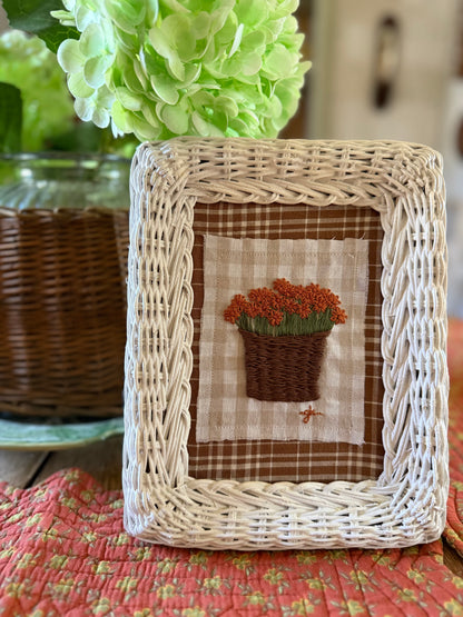 Burnt Orange Mum in Basket Embroidery Art in a White Wicker Frame