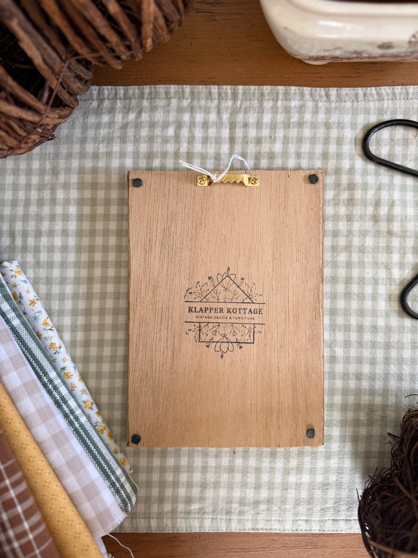 Large White Wicker Frame with Fall Wreath on Green Plaid Fabric in Wooden Vine Frame