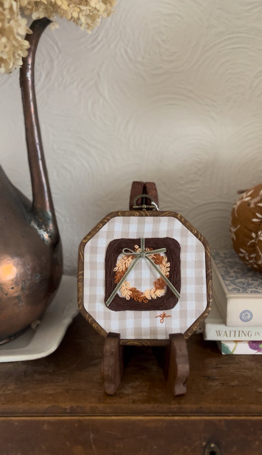 Brown Wicker Frame with Multi-Colored Fall Wreath on Gingham Fabric Embroidery Art